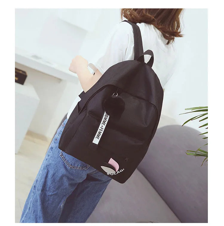 Casual canvas college schoolbag with leaf pattern in green, shown with size and anti-theft features.