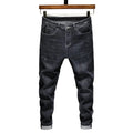 Men's dark grey loose straight-leg cotton denim jeans with mid waist, zip fly and cat whisker finish