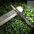 Black portable metal flamethrower with child safety lock for outdoor use