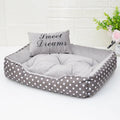 Polka dot print square dog bed with a matching embroidered pillow in grey.