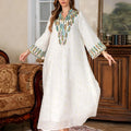 White long sleeve Arabic robe abaya with long skirt on a hanger