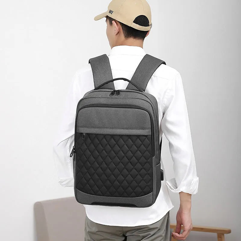 Men's solid colour Oxford cloth travel backpack with diamond mesh panels and curved shoulder straps.