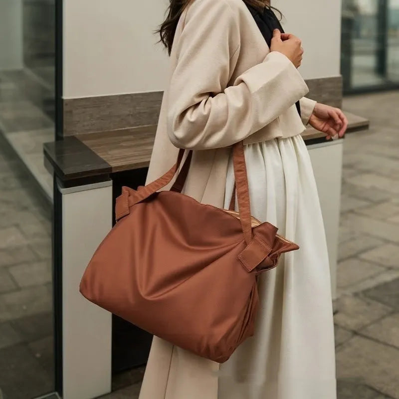 Women's black crossbody shoulder bag made from Oxford cloth with a large expandable storage compartment.