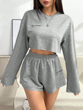 Grey women's long-sleeved polyester top and shorts casual suit set laid flat.