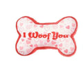 Pet plush tooth cleaning toy with textured surfaces for dental hygiene and vocalisation feature, shown in multiple colour options