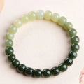 Natural Hetian jade bracelet with gradient clear water colours showing polished beads