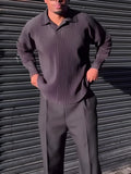 Black men's long-sleeved casual top with pleated detail on the front.