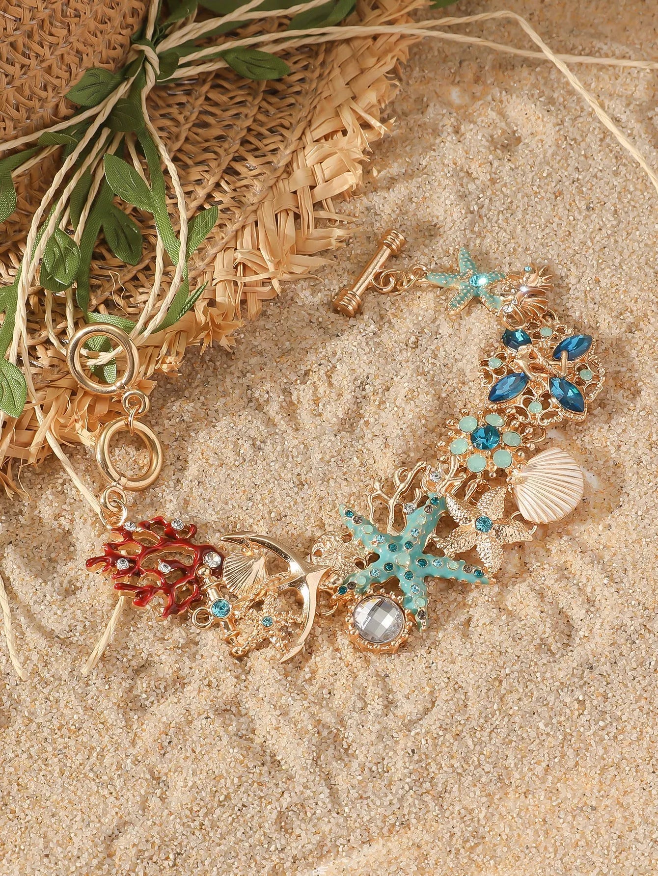 Women's alloy bracelet with starfish design in turquoise, coral red, or coral blue with marine shell and boat anchor elements