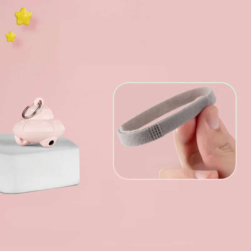 Small green plastic automatic laser toy attached to a cat collar for hands-free interactive pet play.