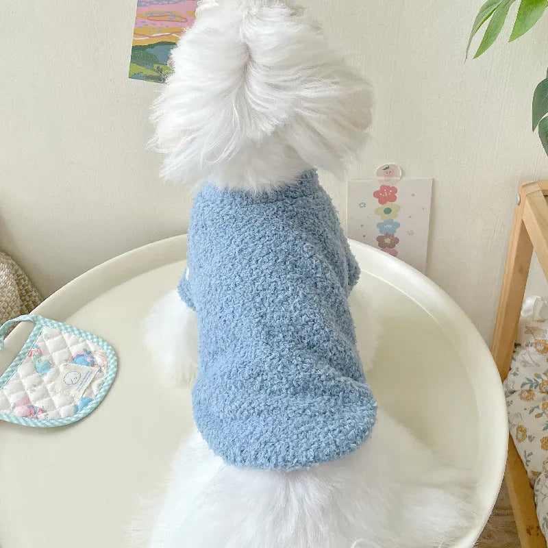 Brown double-sided cloud velvet dog coat with fluffy texture and elastic openings on a small dog.