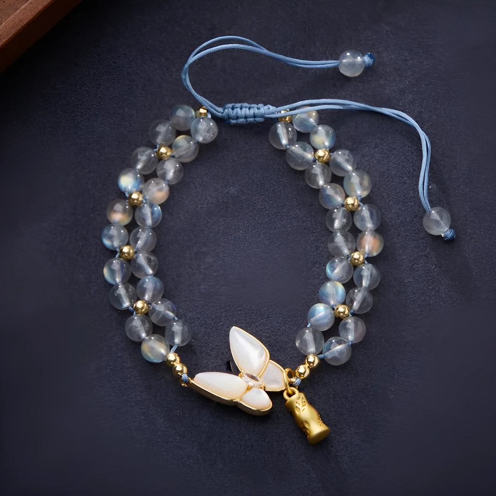 Grey moonstone bracelet with butterfly weave pattern on woven cord