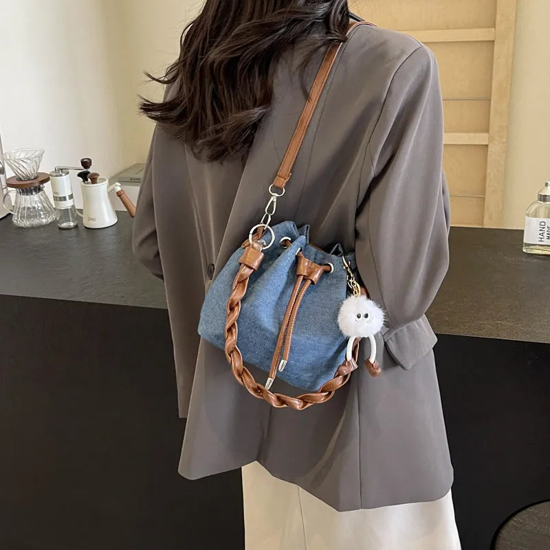 Blue one-shoulder cross body bucket messenger bag with a strap.