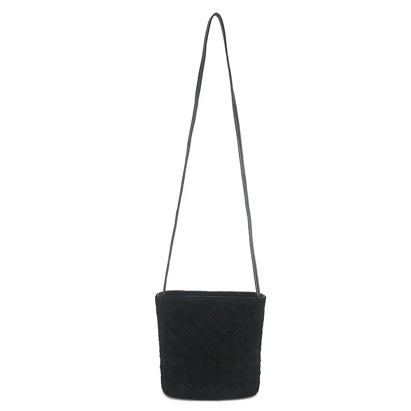 Cowhide leather women's crossbody bag with barrel shape, zip closure, woven detail, and inner patch pocket.