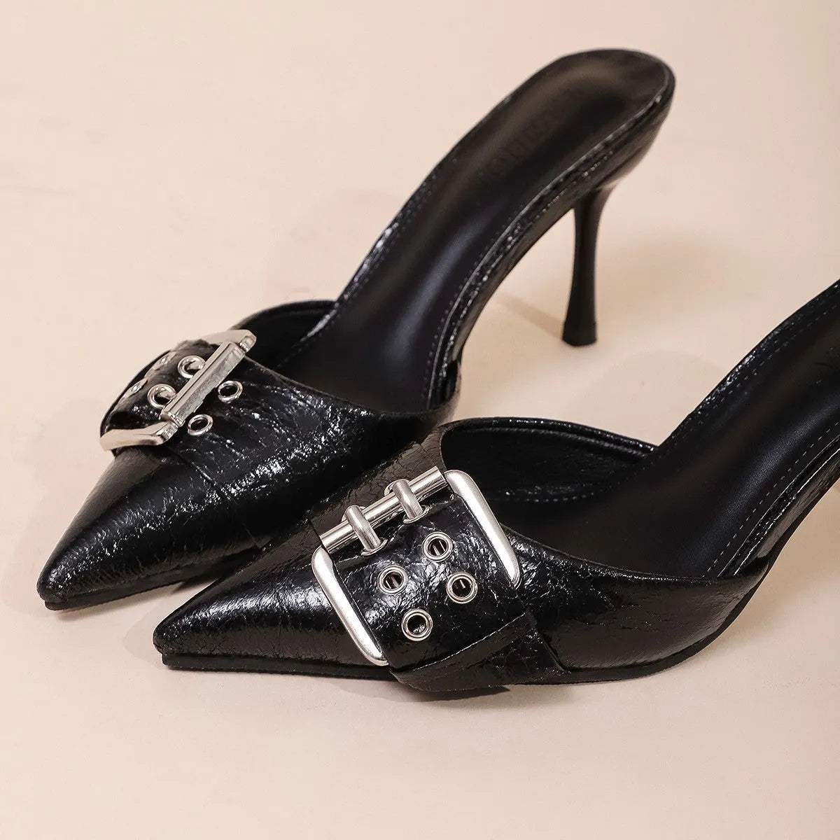 Black women's pointed toe high heels with adjustable ankle strap and decorative buckle fastening