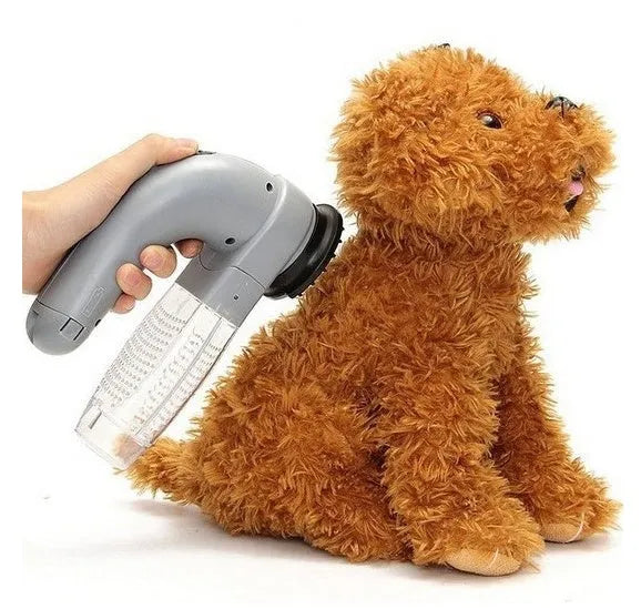 Grey portable pet hair vacuum cleaner and massage brush for dog and cat grooming on sofa