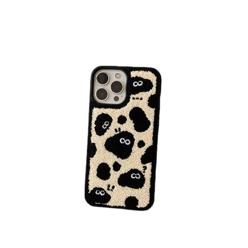 Black plush fairy-themed funny back cover case for iPhone on a table