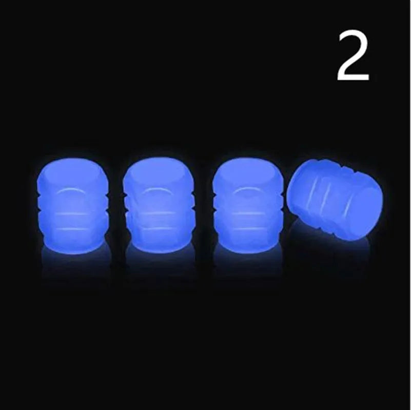 Pack of luminous rubber tyre valve caps glowing in green, blue, red, yellow, and pink colours.