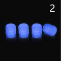 Pack of luminous rubber tyre valve caps glowing in green, blue, red, yellow, and pink colours.
