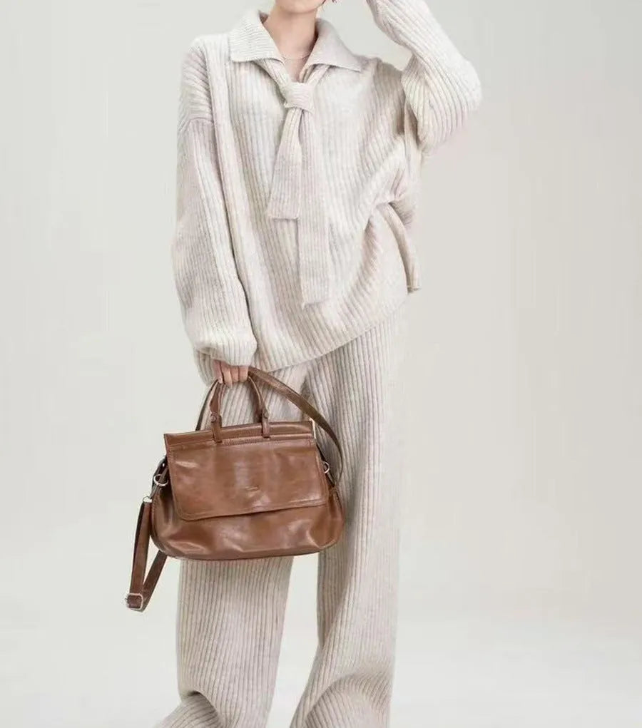 Dark grey sweater suit two-piece set with knit top and trousers showing collage stitching detail
