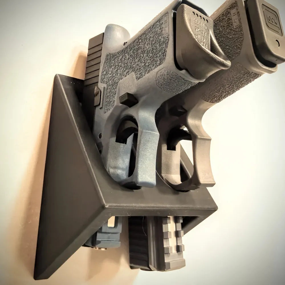 Black plastic pistol stand for displaying collectible firearms, dimensions 10.85 x 7.6 cm