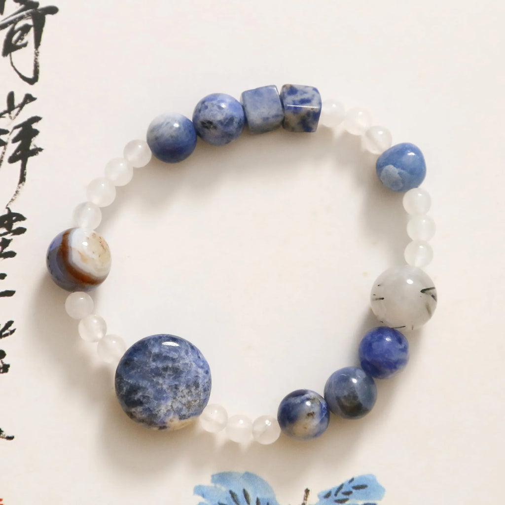 Hand-woven natural stone bracelet with blue point stone and black hair crystal agate in geometric design