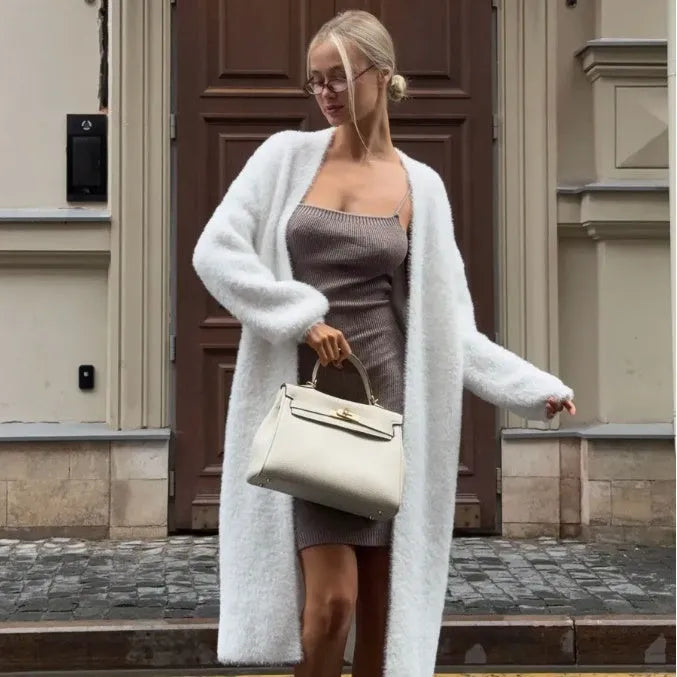 White women's knitted cardigan jacket with 105cm length and loose fit, shown in commute style
