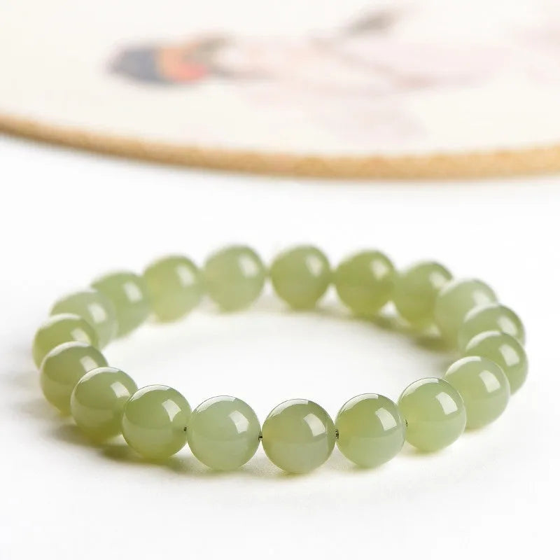Hetian jade ball bracelet with polished beads in ice-like clear water colours, showing 4mm to 10mm size options