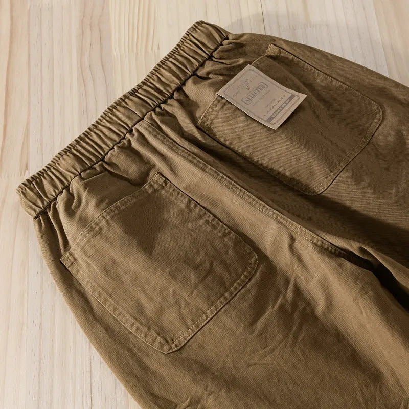 Men's cotton overalls with drawstring waist and ankle banded leg in army green colour.