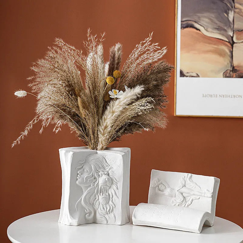 Ceramic book stand in lover design with glazed surface, approximately 15cm tall, on a wooden desk