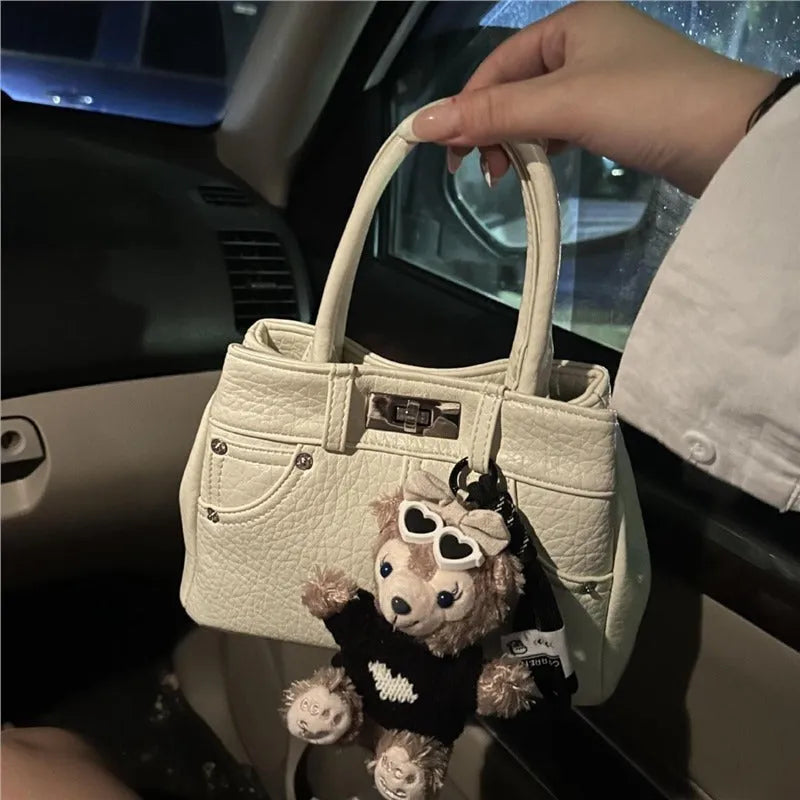 Women's casual shoulder bag in denim blue or white colour made from soft PU material