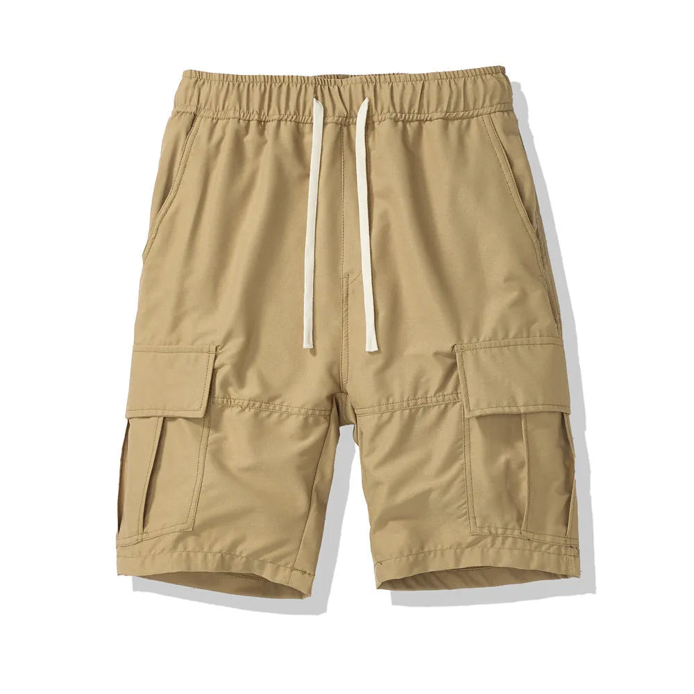 Man wearing loose black cropped pants with multiple pockets for outdoor summer leisure.