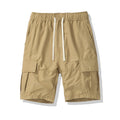Man wearing loose black cropped pants with multiple pockets for outdoor summer leisure.