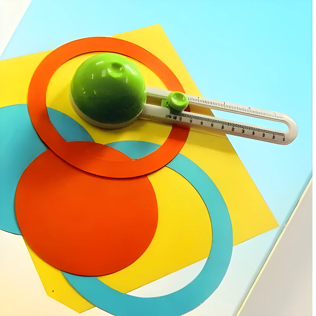 Orange or green plastic round paper cutter on a colour box, capable of cutting A3 paper.