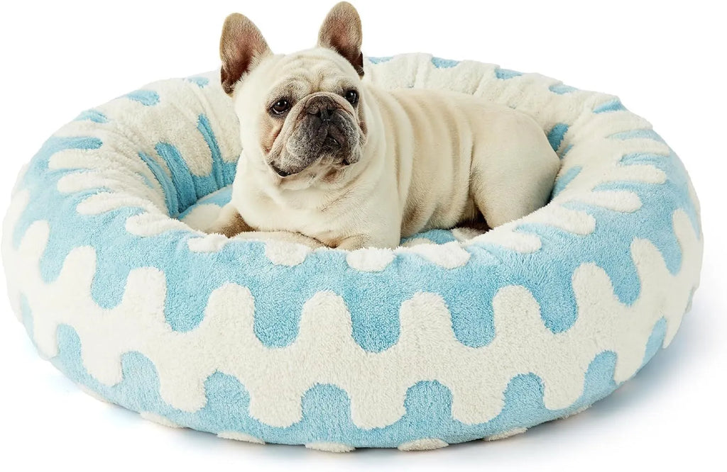 Round plastic dog bed with a blue and white plaid removable cover, shown in a 60x60cm size.