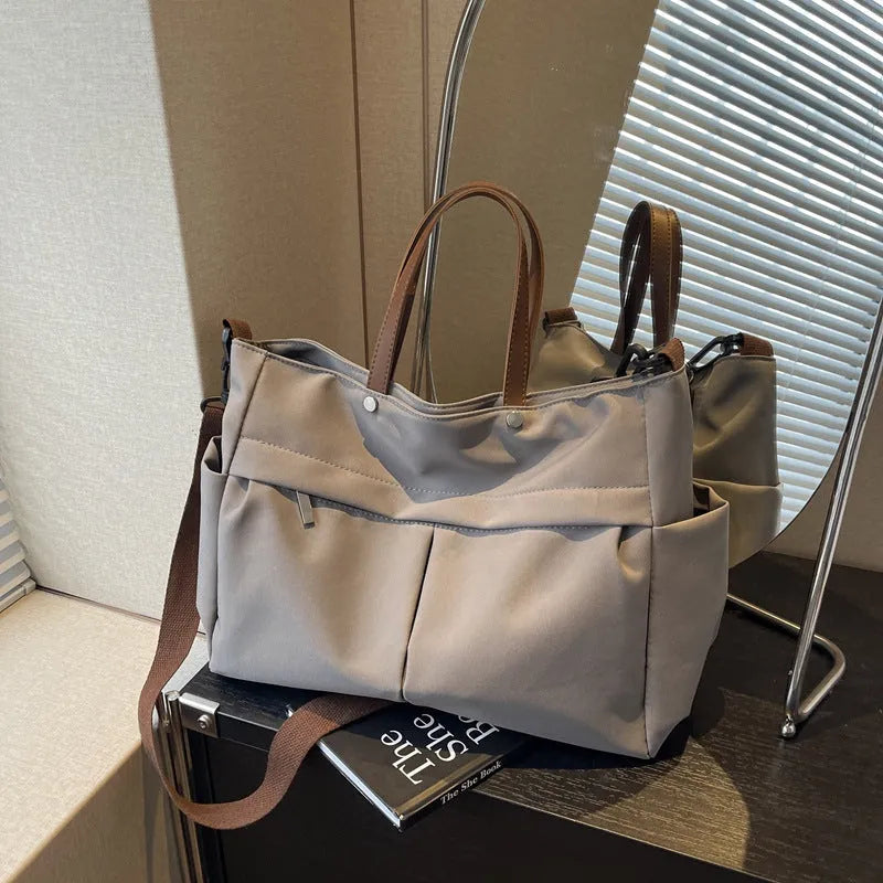 Nylon crossbody tote bag with shoulder strap in black, grey, white, or green
