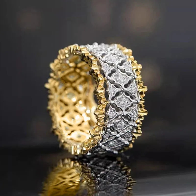 Geometric two-tone zircon ring on finger showing copper construction with electroplated finish and round stone