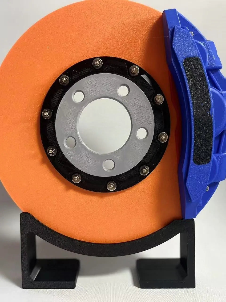 Blue brake disc LED rechargeable night light with touch dimmer on a desktop