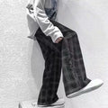 Men's black and green plaid trousers with straight leg design and mid-rise waistband