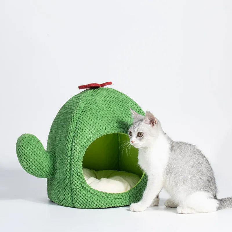 Green cactus-shaped enclosed cat bed with soft fluffy fabric and a plush interior for pets.
