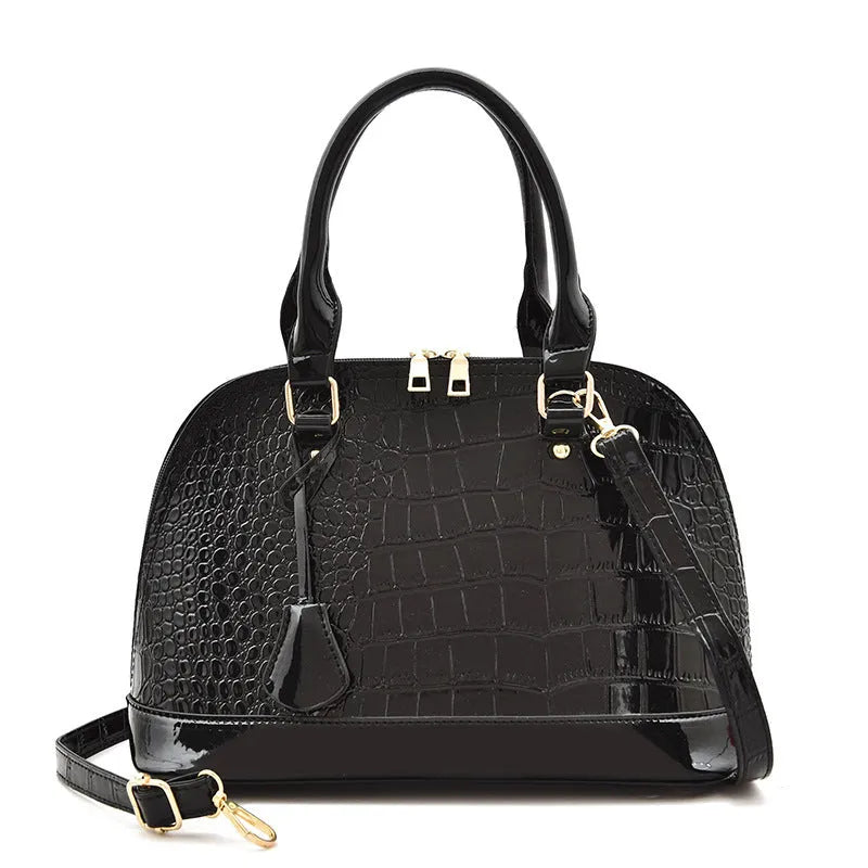 Large shiny crossbody shoulder bag with shell shape design showing 22x30x15cm dimensions