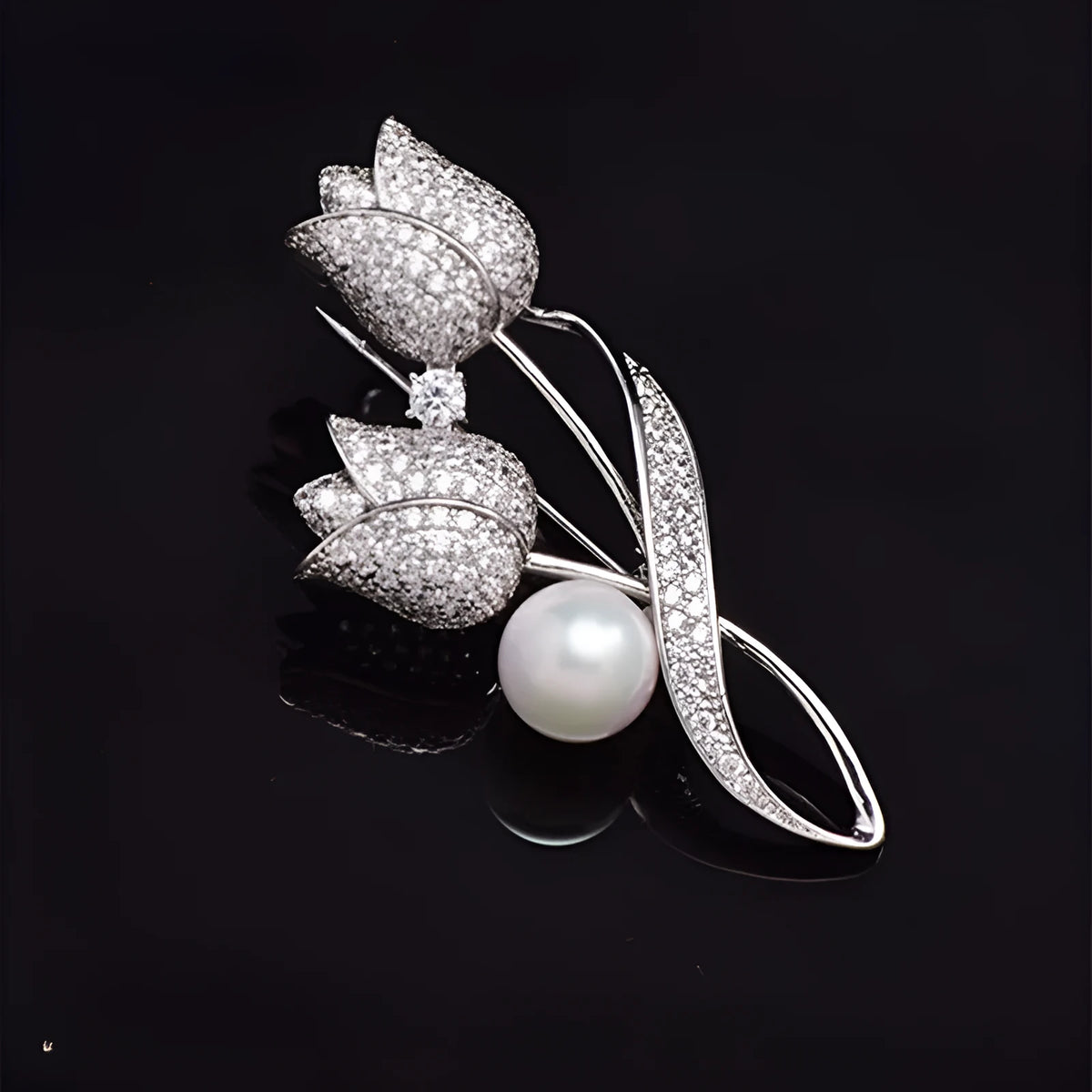 Close-up of a silver tulip coloured flower brooch with micro-inlaid zircon stones on a dark background.