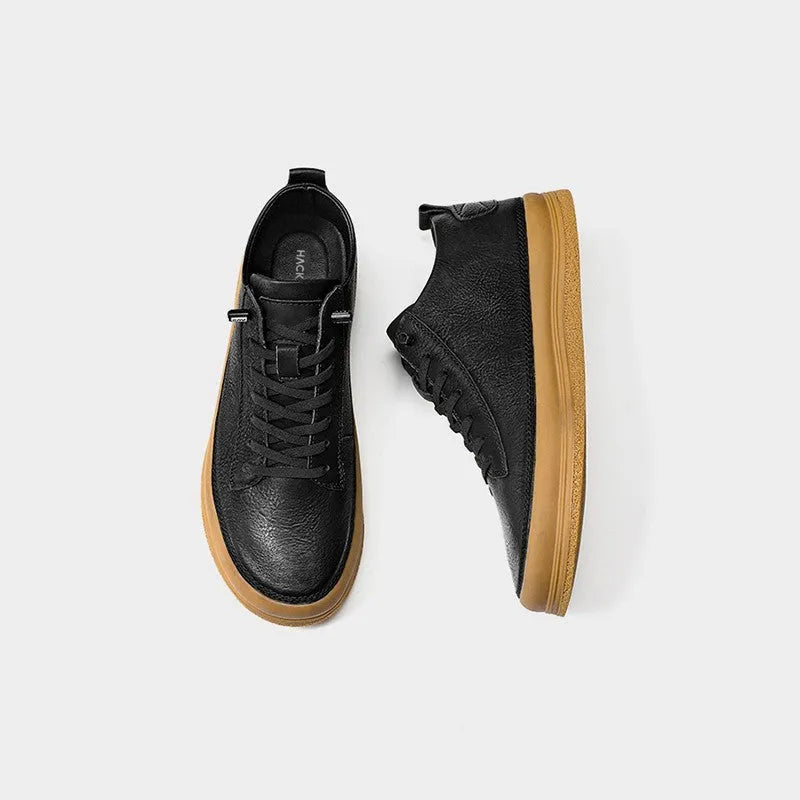 Men's black casual leather shoes with round toe, flat heel, and lanyard closure on neutral background
