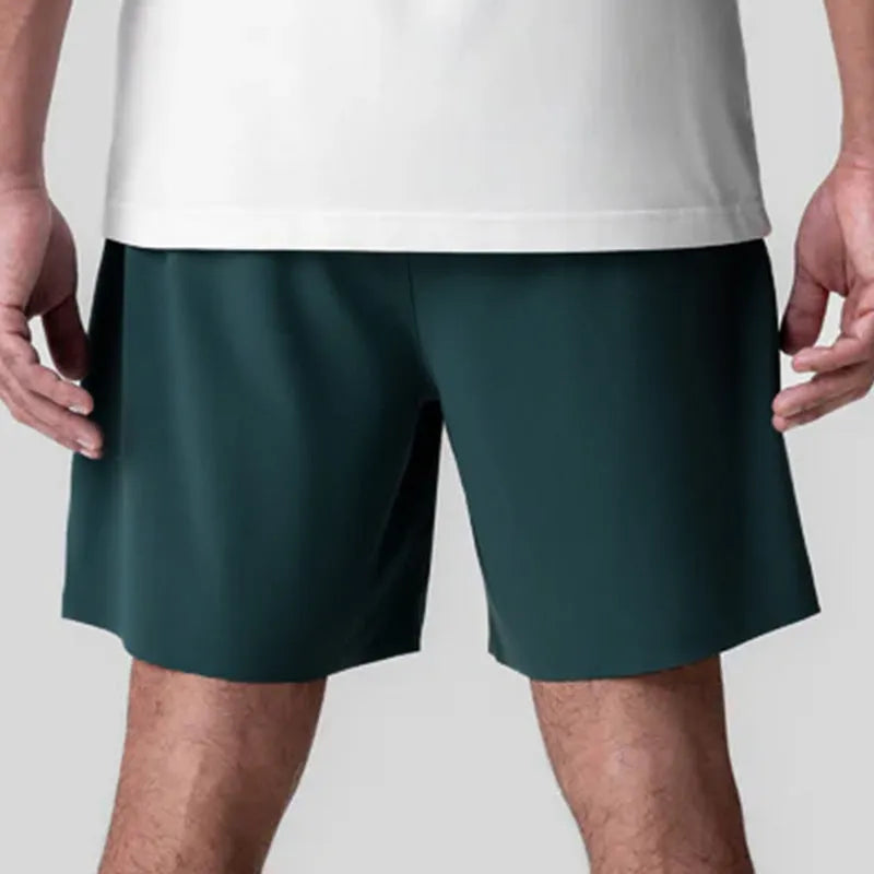 Men's grey seamless sports shorts with knee-length straight leg design and quick-dry fabric