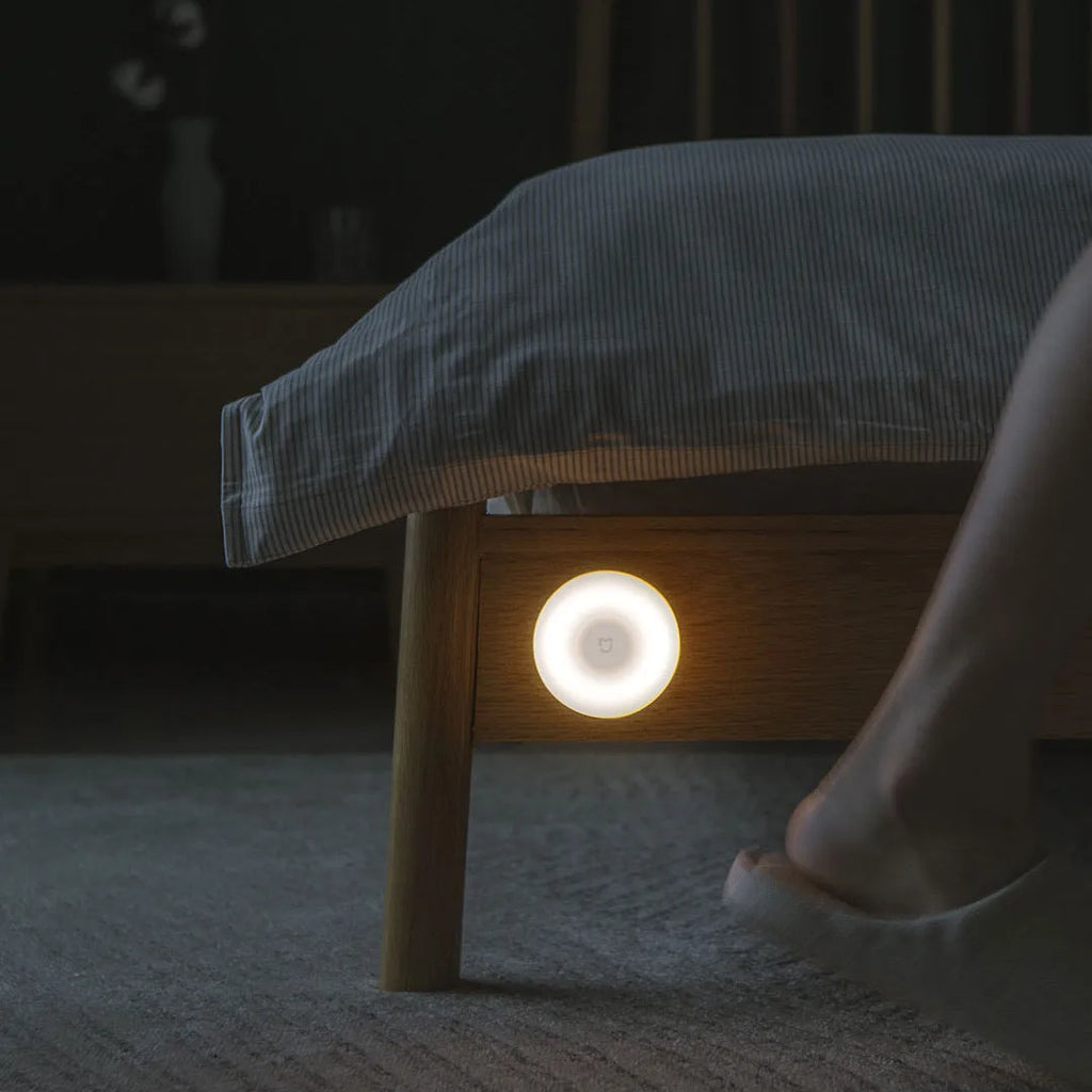 White Mijia Night Light 2 Bluetooth bedside lamp with human body induction, 94mm width, on wooden table