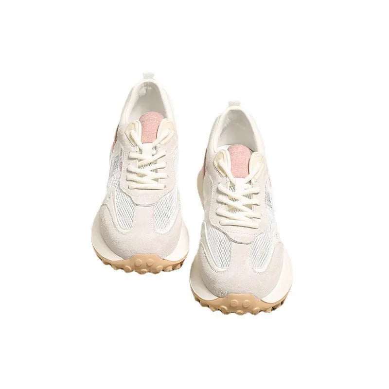 Women's grey and pink low-top retro sneaker with round toe and flat rubber sole.