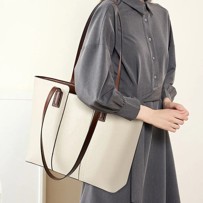 Women's black genuine cowhide leather commuter bag showing internal zipper change bag, mobile phone pocket, file compartment, and crossbody strap