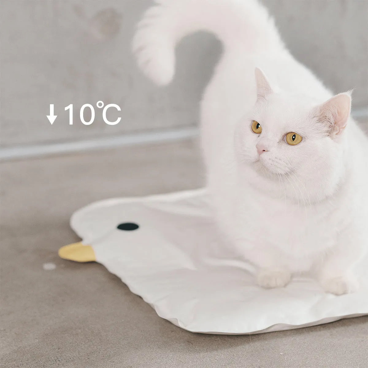 Blue chick-shaped washable pet cooling mat on a wooden floor.
