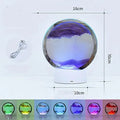 Creative 3D quicksand table lamp with glass shade on a table, showing touch control and USB cable.
