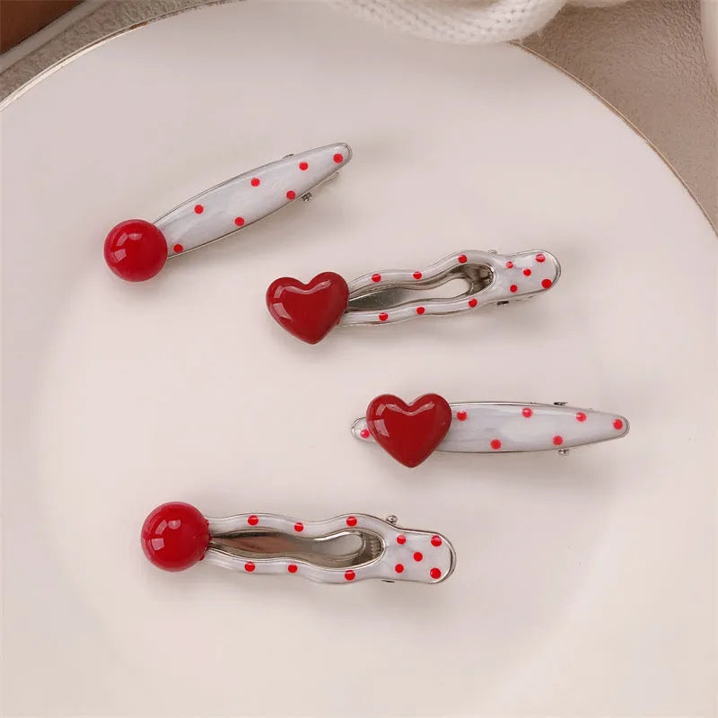 Red three-dimensional love heart-shaped hair barrette with retro dots and a willow leaf design.