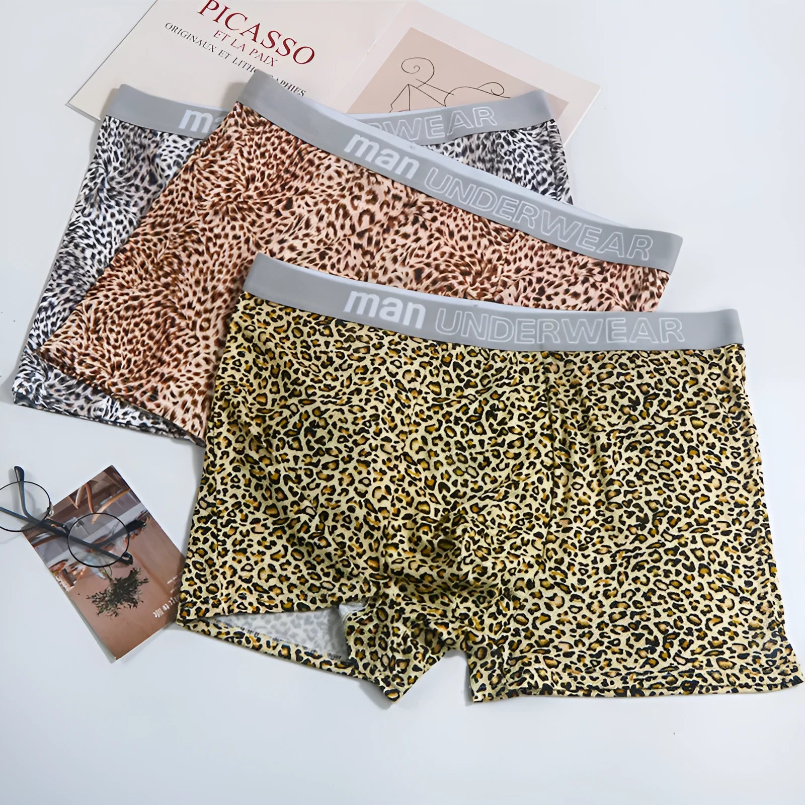 Men's leopard print underwear in milk silk polyester fabric showing loose fit and mid waist design